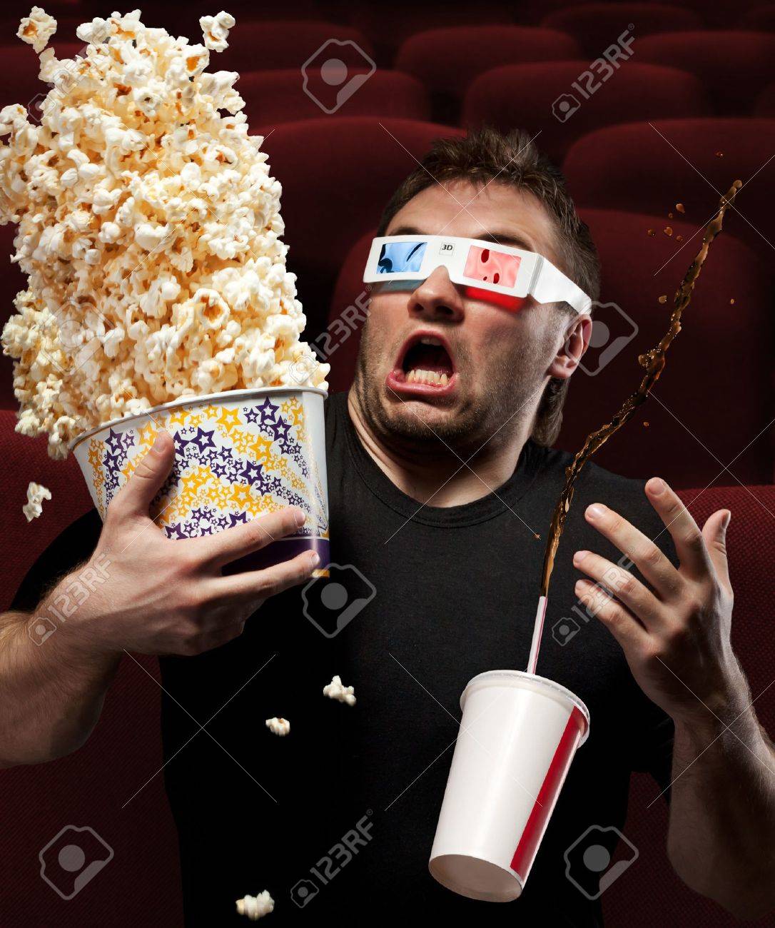 Portrait Of Very Scared Man Watching 3D Movie, Drinking Cola And Eating  Popcorn Stock Photo, Picture and Royalty Free Image. Image 18055833.
