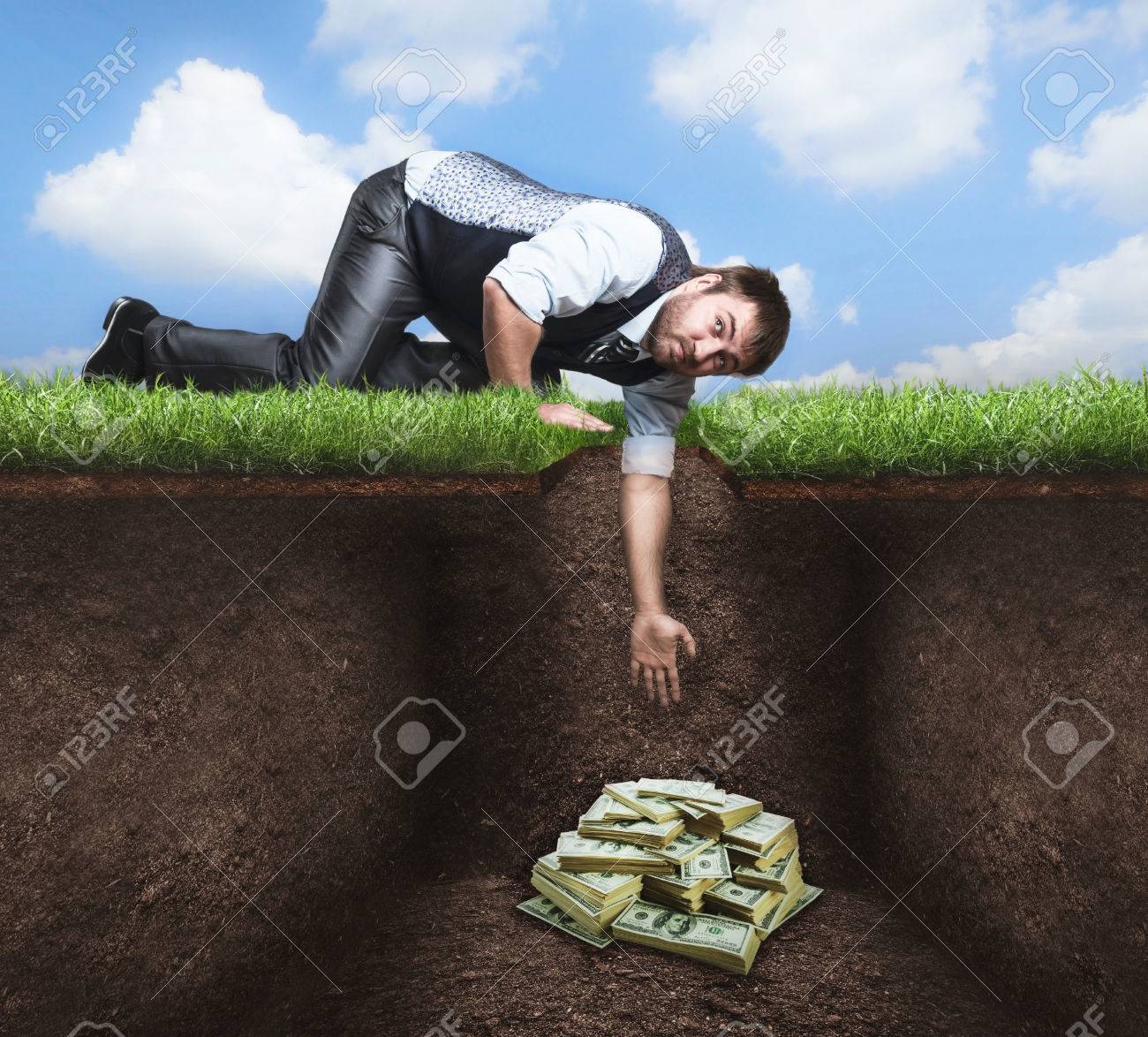 Businessman On Knees Tries To Get Treasure In The Soil Stock Photo Picture And Royalty Free Image Image