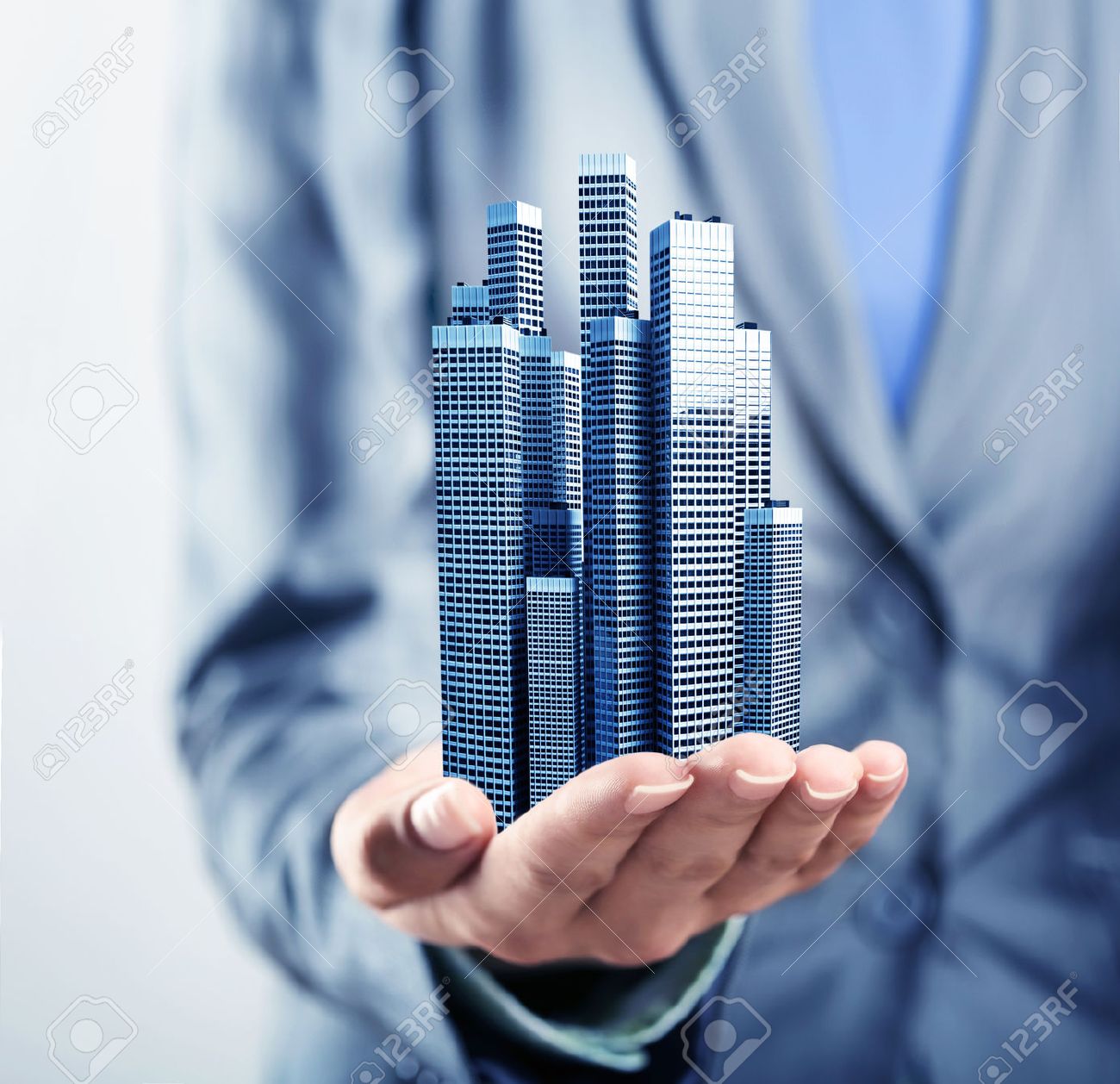 Office buildings standing on the human palm - 45584500 Office buildings standing on the human palm - 45584500