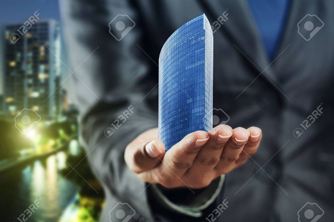 Small office building standing on the human palm - 45587392 Small office building standing on the human palm - 45587392