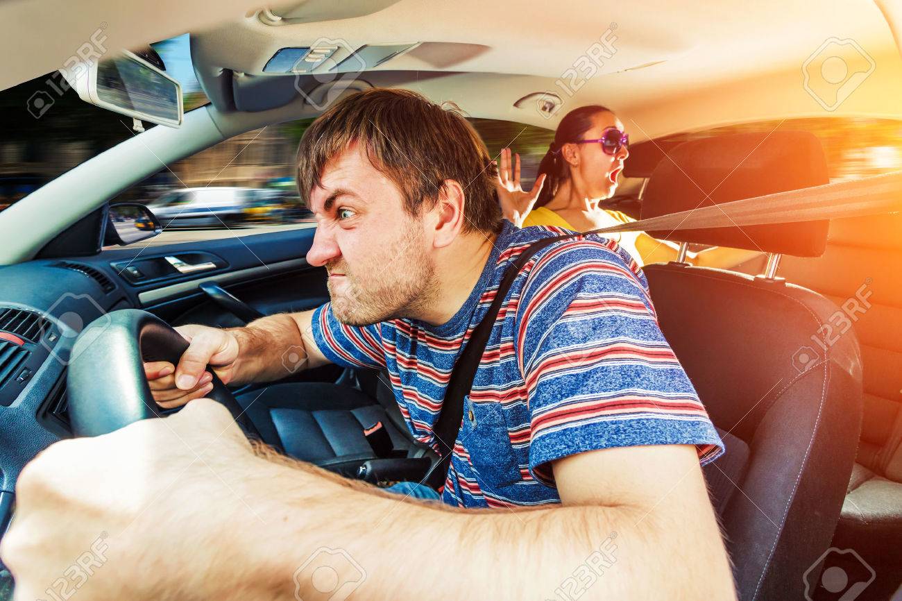 Angry man driving the car, woman on the back seat is scared - 60949525 Angry man driving the car, woman on the back seat is scared - 60949525
