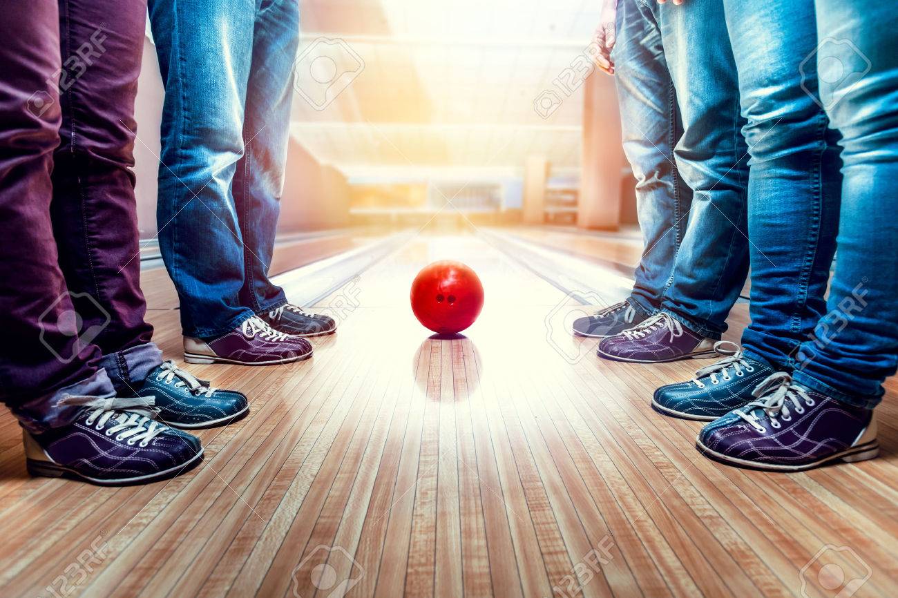 Many people standing near bowling ball on the lane - 63486204 Many people standing near bowling ball on the lane - 63486204