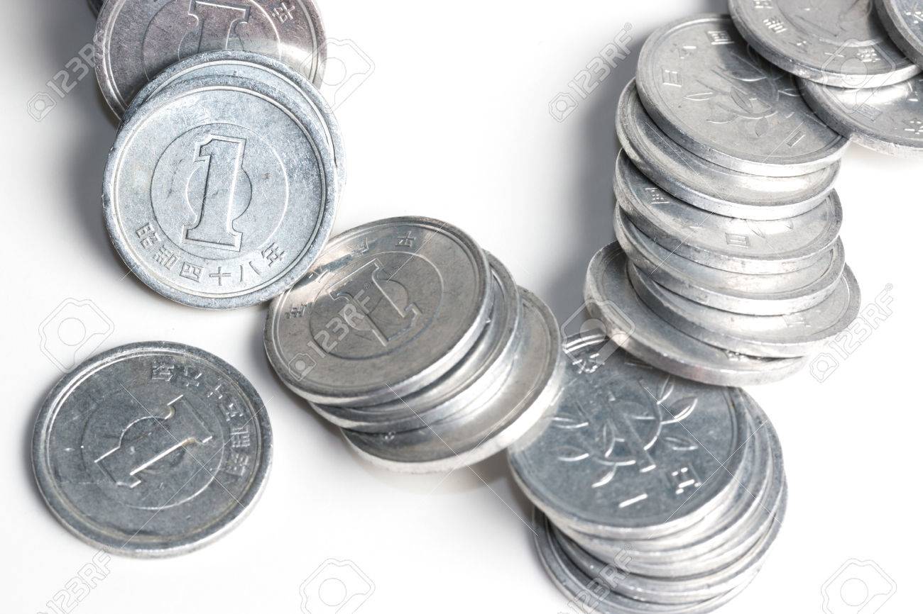 pile of 1 yen coins japanese money close up isolated on white