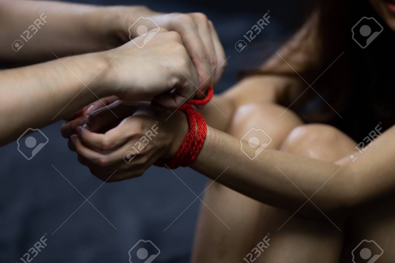 Stop Violence Against Women. Victim Women Tied Up With Red Rope. Sexual  Abuse Or Rape In The Dark Room Stock Photo, Picture and Royalty Free Image.  Image 157786850.