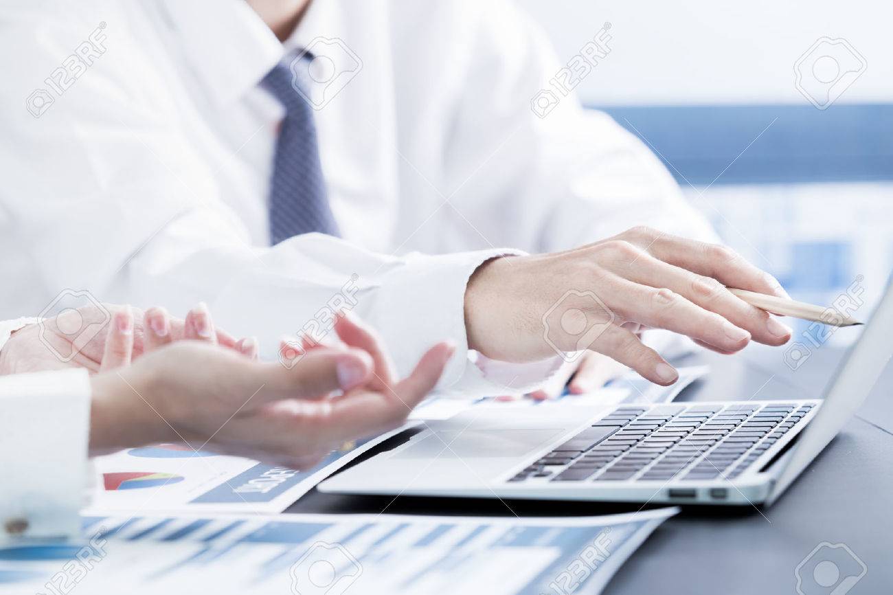 Business people discussing the charts and graphs showing the results of their successful teamwork - 51957255 Business people discussing the charts and graphs showing the results of their successful teamwork - 51957255