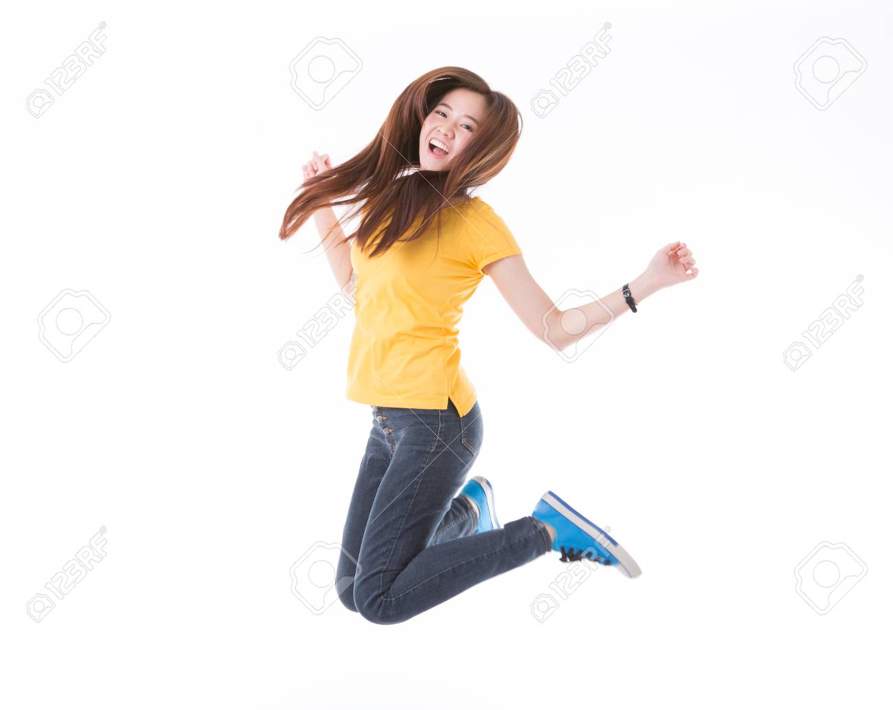 Jumping female college / university student isolated on white background. Young woman Asian Caucasian students. - 65861023 Jumping female college / university student isolated on white background. Young woman Asian Caucasian students. - 65861023