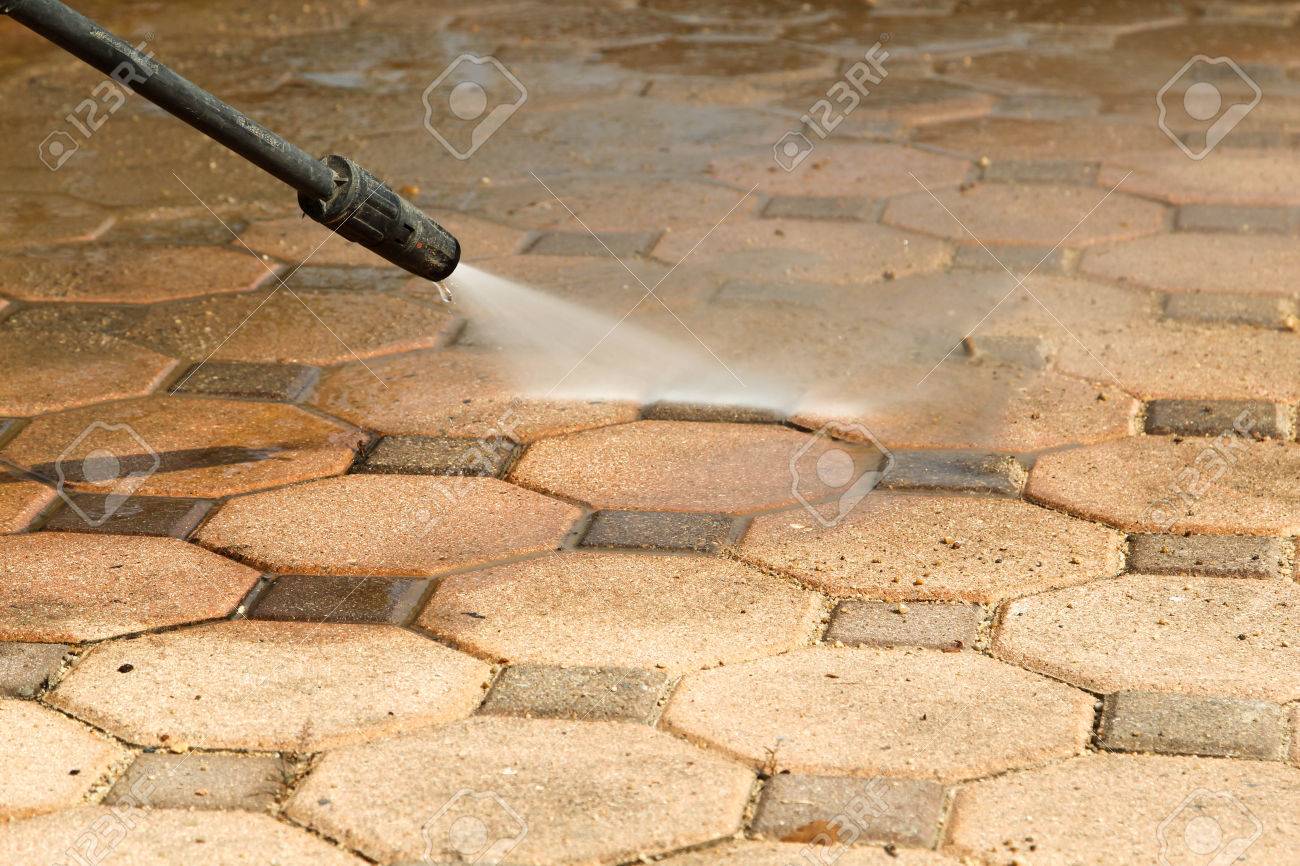 Cleaning concrete block floor by high pressure water jet. - 65322609 Cleaning concrete block floor by high pressure water jet. - 65322609