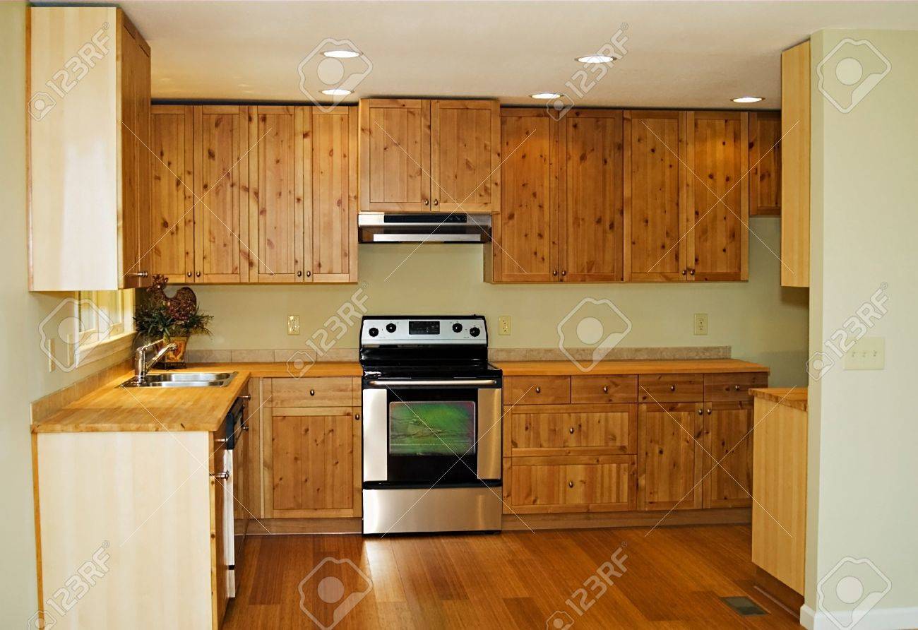 the interior of a new, small, kitchen with bamboo flooring and the interior of a new, small, kitchen with bamboo flooring and