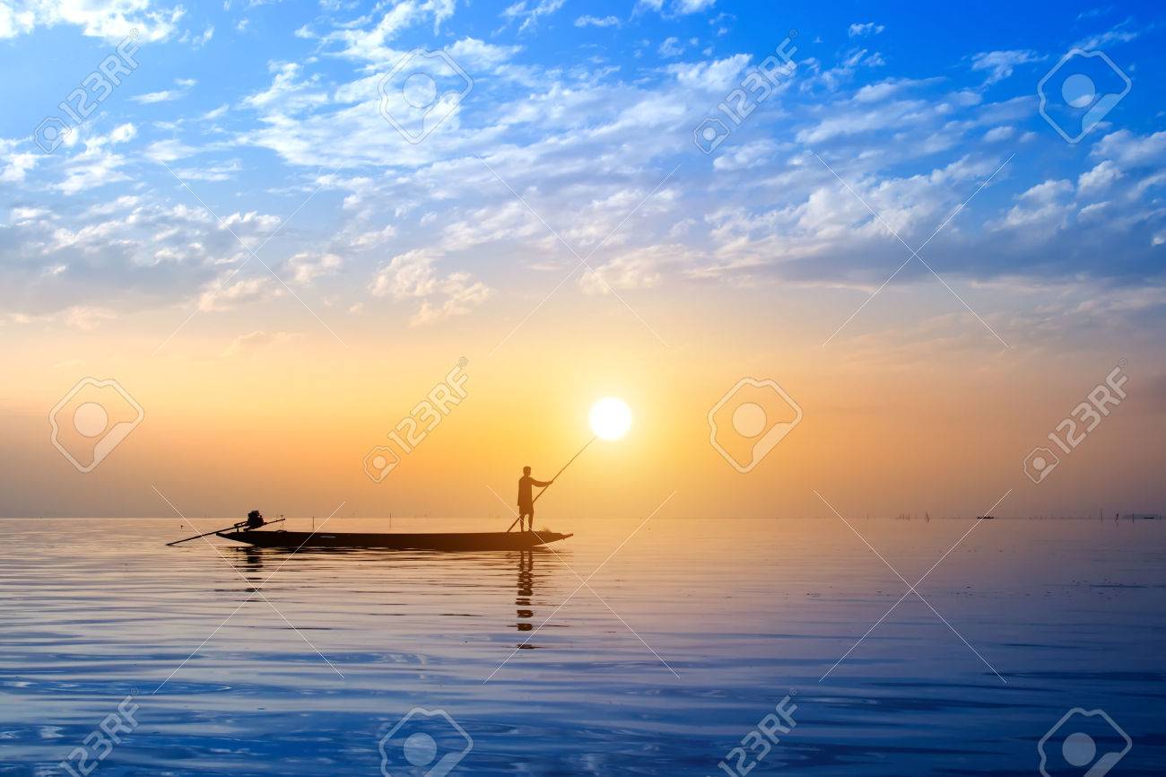 Beautiful sky and Silhouettes of Minimal fisherman at the lake, Thailand. - 43973114 Beautiful sky and Silhouettes of Minimal fisherman at the lake, Thailand. - 43973114