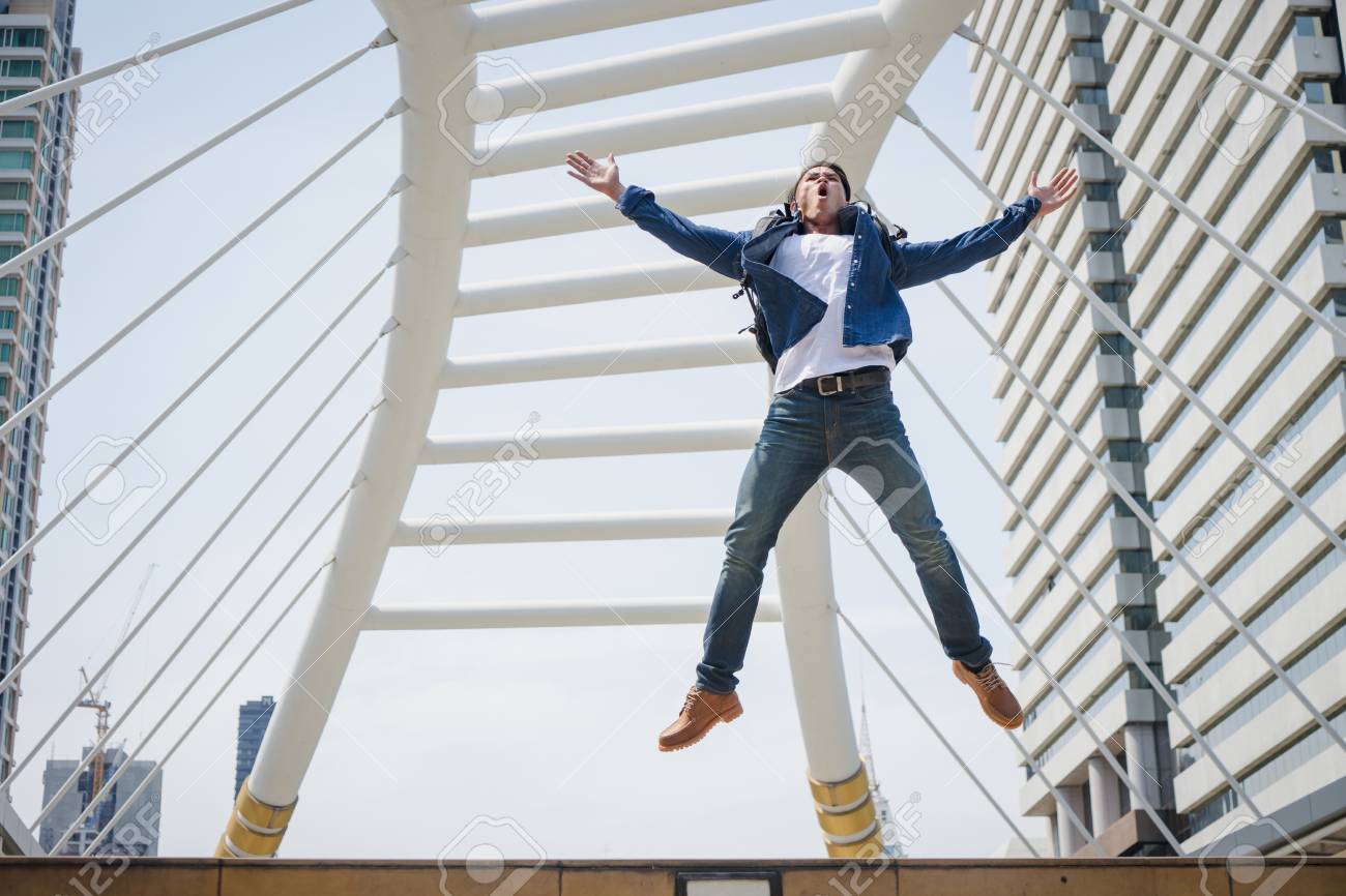 traveler man jumping with city building on background tourist