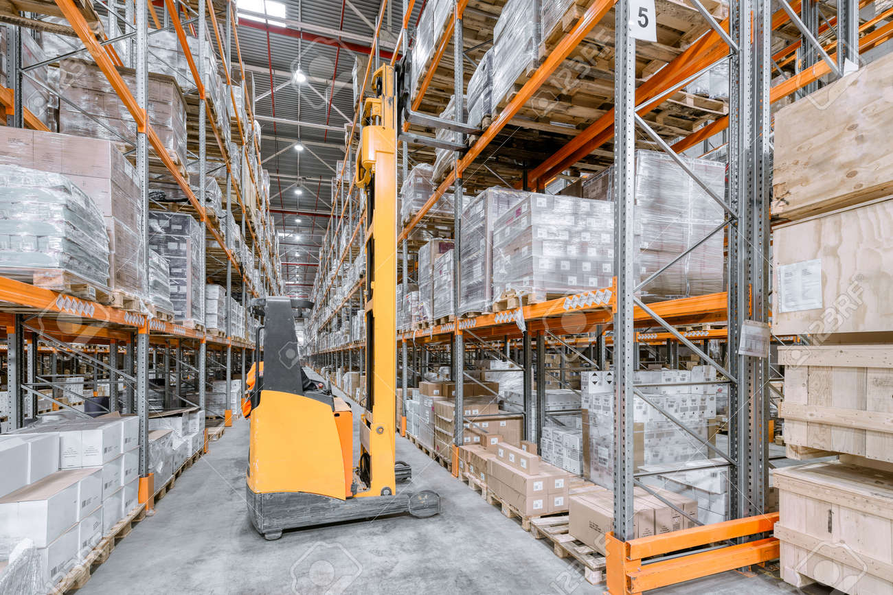 Large warehouse. Tall and long metal racks filled with various boxes, containers and drawers - 156084178 Large warehouse. Tall and long metal racks filled with various boxes, containers and drawers - 156084178