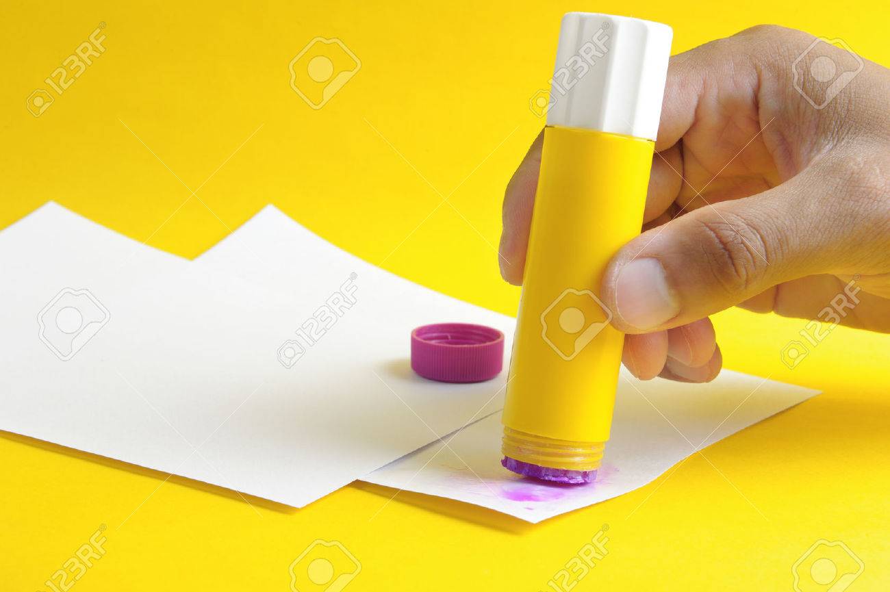 Applying Purple Glue Stick To White Paper Stock Photo, Picture and Royalty  Free Image. Image 32052565.