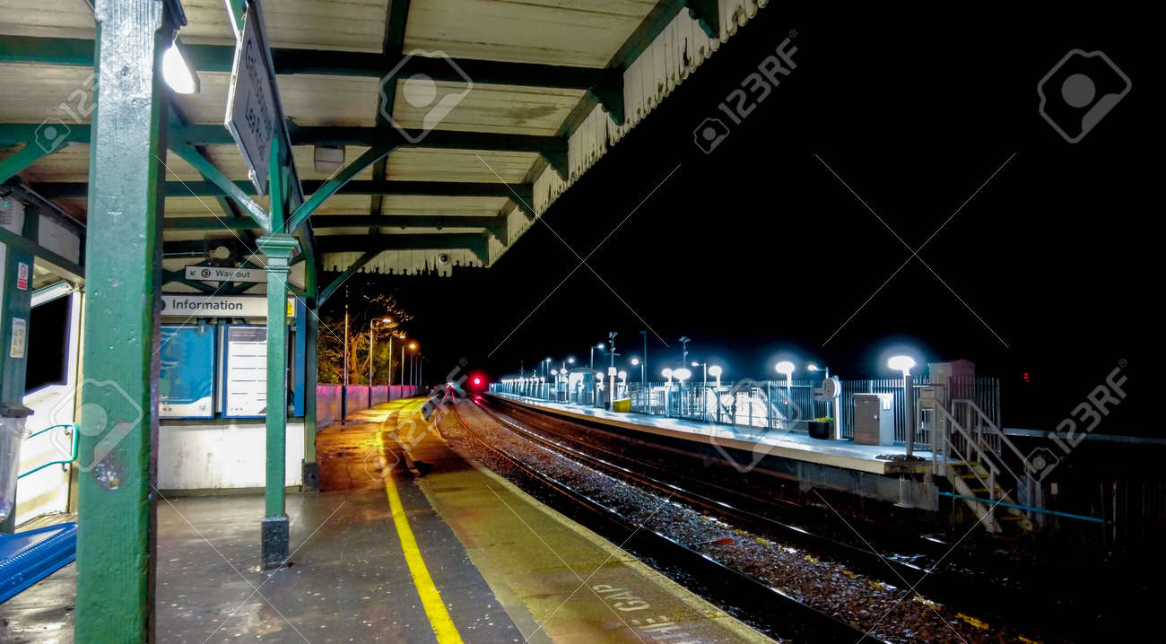 Passengers hurry along a platform in a London train station so they can board the train to get them to their next destination. - 166119409 Passengers hurry along a platform in a London train station so they can board the train to get them to their next destination. - 166119409