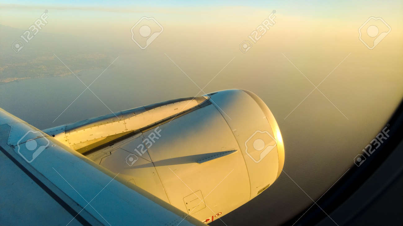 A view from a passenger window of a large aircraft traveling across the world on a holiday or business trip. - 166119405 A view from a passenger window of a large aircraft traveling across the world on a holiday or business trip. - 166119405