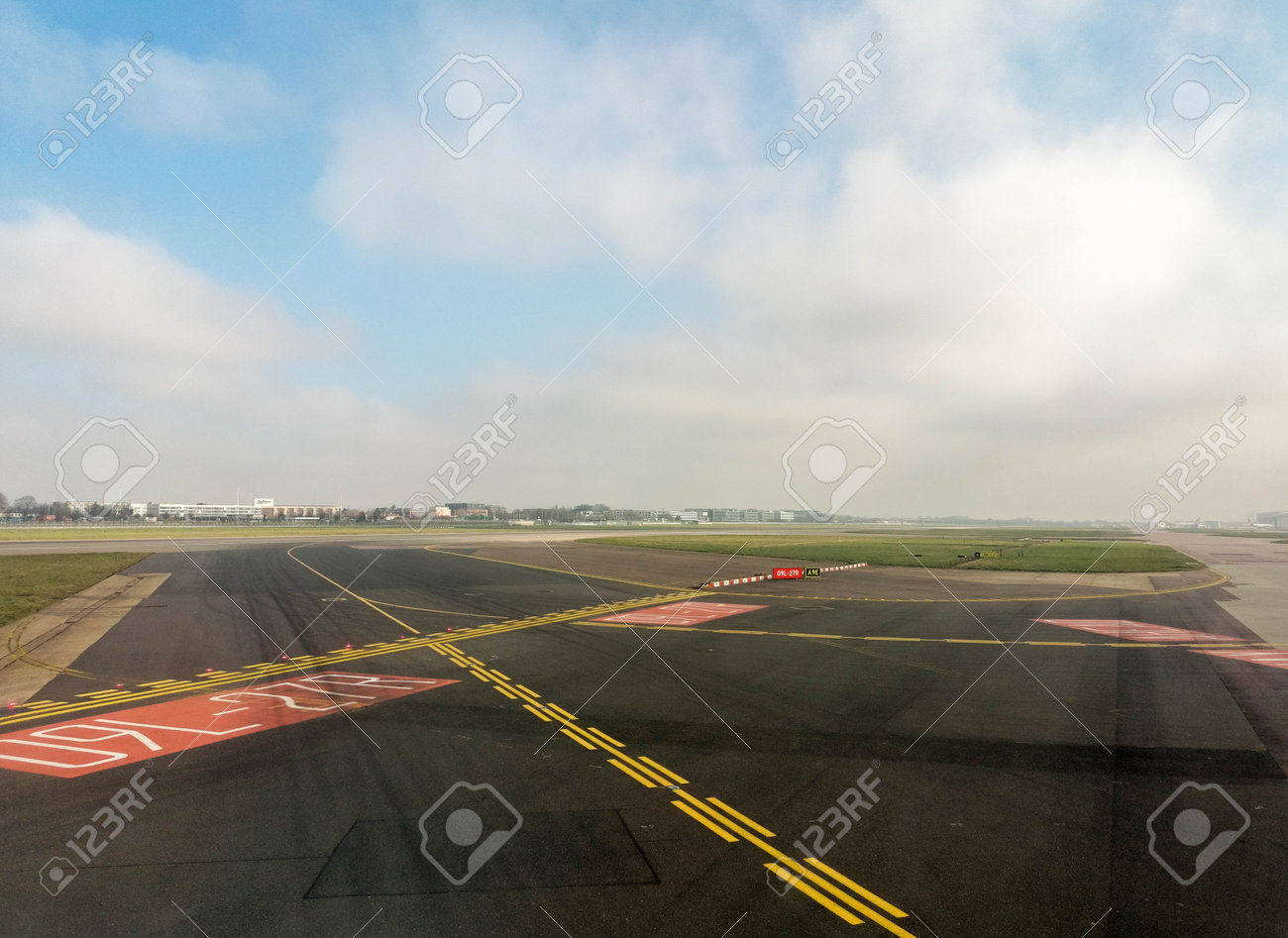 A passenger view from onboard a passenger aircraft of an airport area before the plane departs or just after it has arrived. - 166119415 A passenger view from onboard a passenger aircraft of an airport area before the plane departs or just after it has arrived. - 166119415