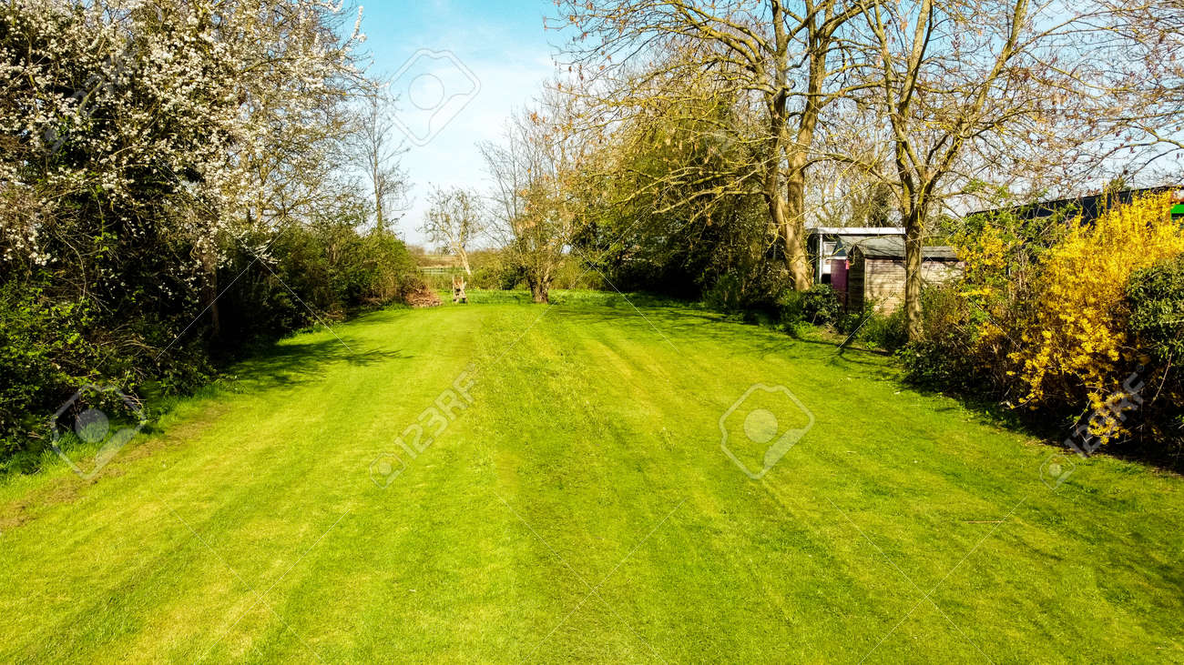 A long garden at the rear of a small property, in England, United Kingdom. The view seen from a drone high up above the property. - 168149674 A long garden at the rear of a small property, in England, United Kingdom. The view seen from a drone high up above the property. - 168149674
