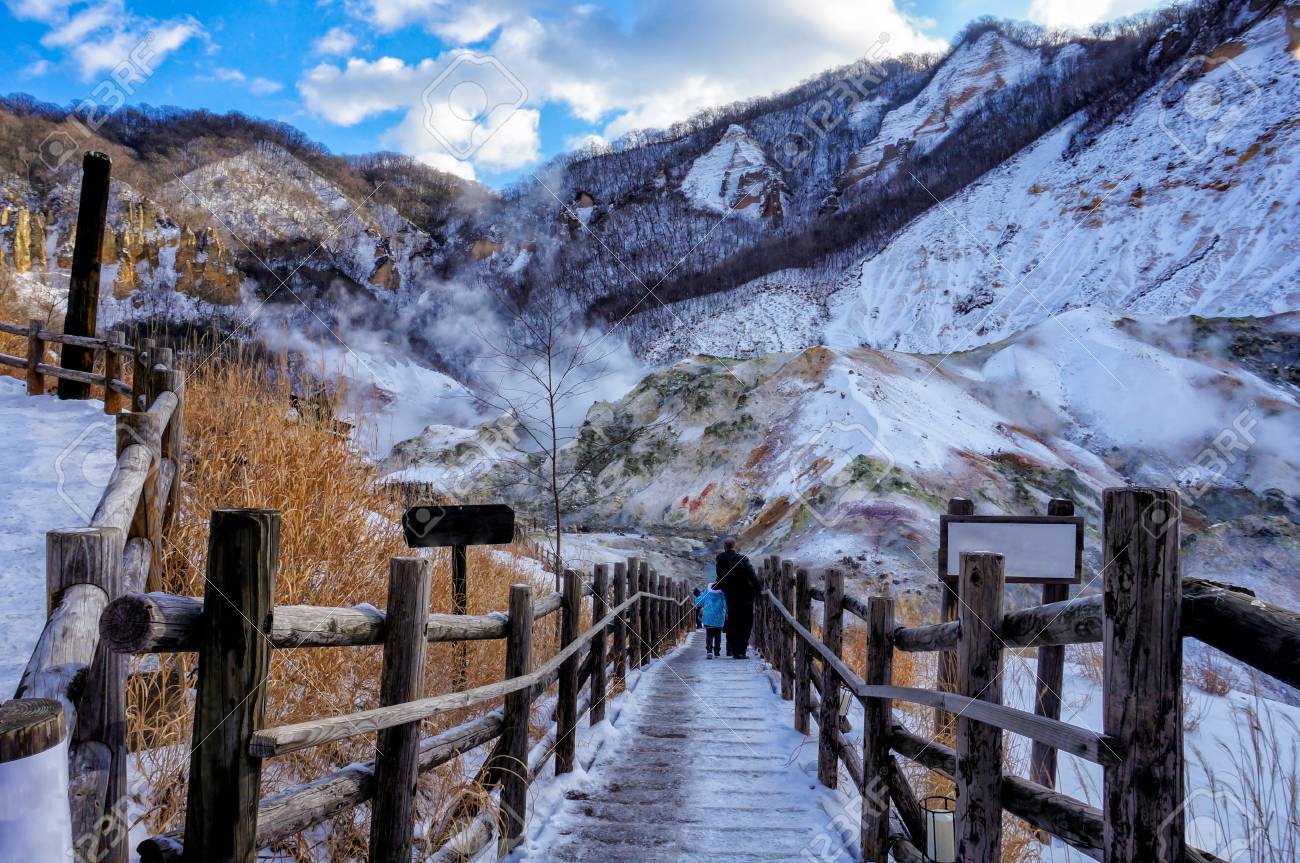 Traveler walking into Jigokudani, known in English as "Hell Valley" is the source of hot springs for many local Onsen Spas in Noboribetsu, Hokkaido, Japan in winter - 92441676 Traveler walking into Jigokudani, known in English as "Hell Valley" is the source of hot springs for many local Onsen Spas in Noboribetsu, Hokkaido, Japan in winter - 92441676