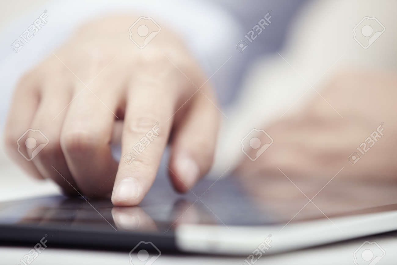Hands of businessman using tablet PC at office - 14303042 Hands of businessman using tablet PC at office - 14303042