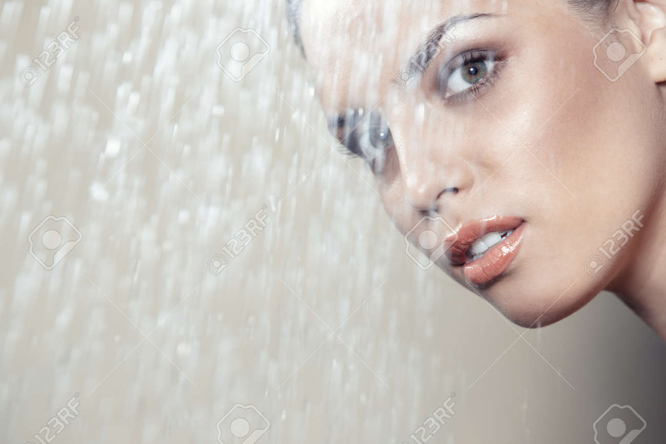 Attractive lady behind the water falling - 14477771 Attractive lady behind the water falling - 14477771