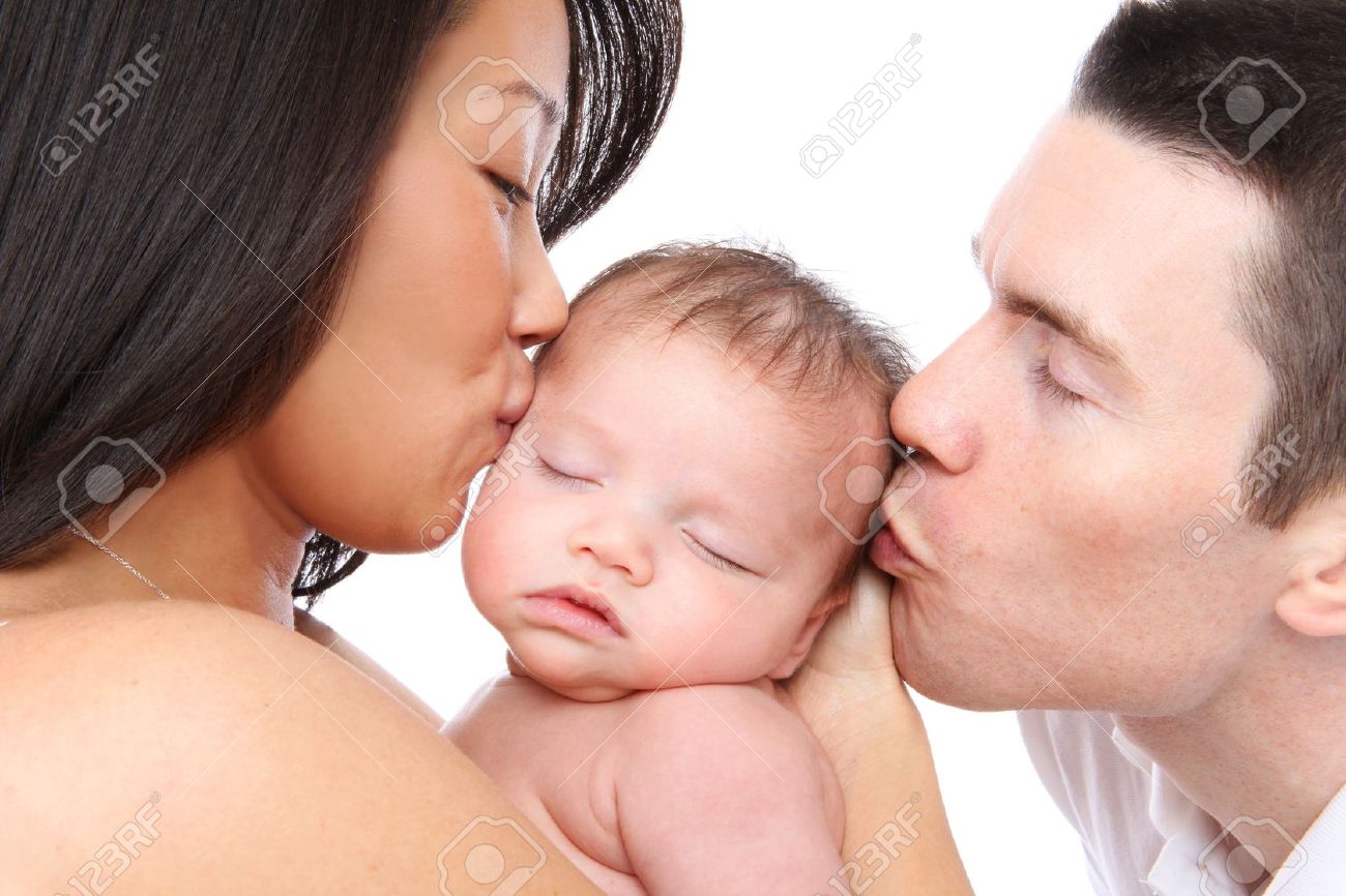 A Mom And Dad Parent Kissing Their Young Baby Stock Photo Picture And Royalty Free Image Image