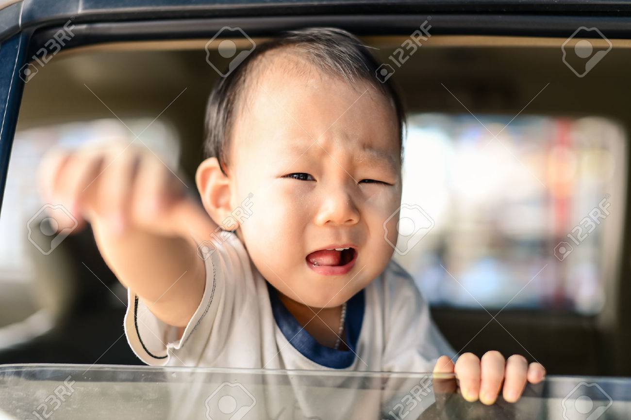 Crying Asian baby in car, safety concept. - 33336636 Crying Asian baby in car, safety concept. - 33336636