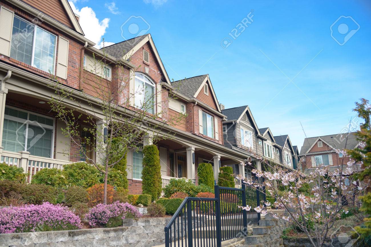 American street with townhouses with nice landscaping under blue sky - 38066893 American street with townhouses with nice landscaping under blue sky - 38066893