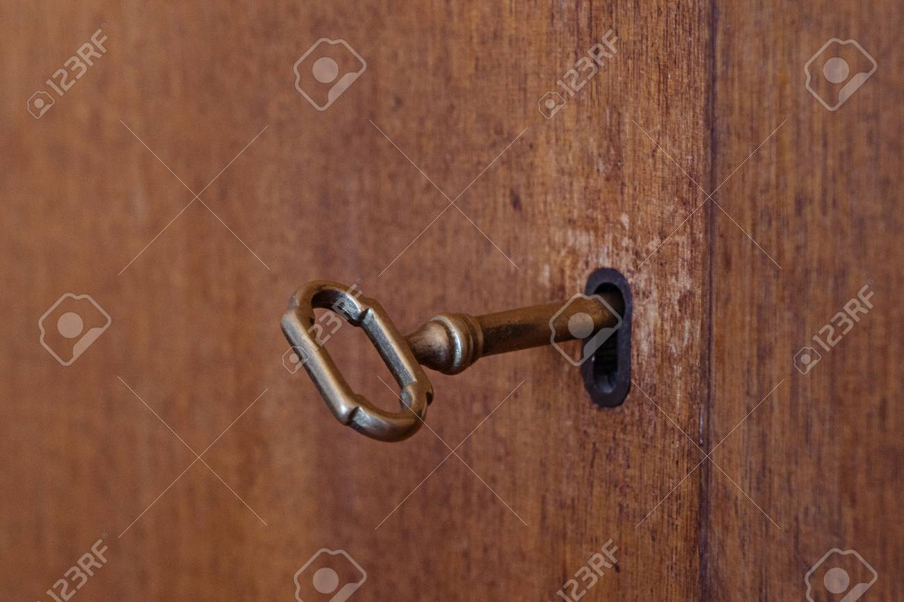 Old Wooden Cabinet With Vintage Key In Keyhole Shallow Depth