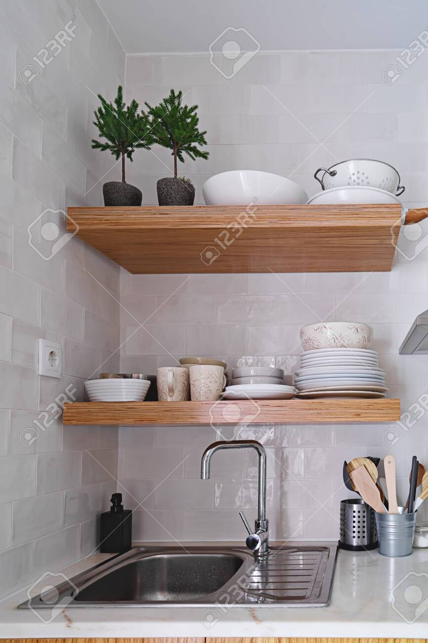 Wooden Kitchen Shelves With Tableware On White Brick Tile Wall Stock Photo Picture And Royalty Free Image Image 154583451
