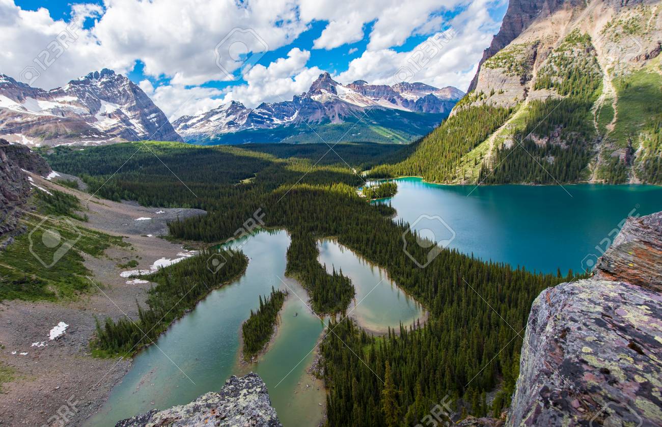 Opabin lake beautiful hiking trail in cloudy day in Spring, Yoho, Canada. - 115343604 Opabin lake beautiful hiking trail in cloudy day in Spring, Yoho, Canada. - 115343604