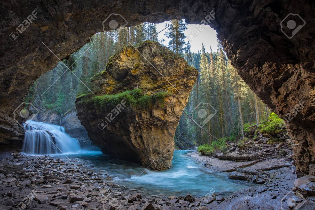 Johnston Canyon cave in Spring season with waterfalls, Johnston Canyon Trail, Alberta, Canada. - 115343517 Johnston Canyon cave in Spring season with waterfalls, Johnston Canyon Trail, Alberta, Canada. - 115343517