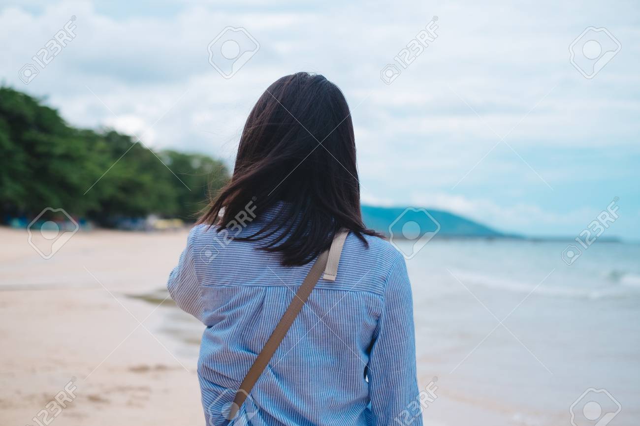 alone girl walking on beach