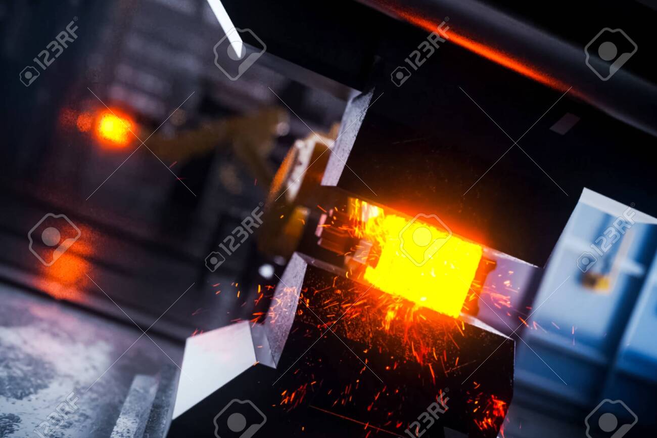 Hot metal billet under the press. Conveyor line of a plant for the production of metal products. - 140765450 Hot metal billet under the press. Conveyor line of a plant for the production of metal products. - 140765450