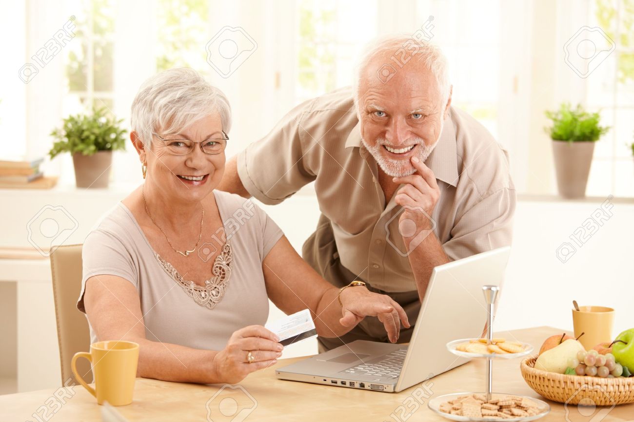 Senior couple using online banking with future tech