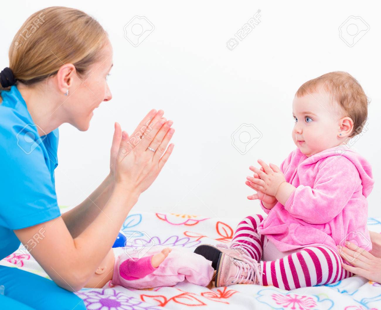 photo of babysitter playing with an adorable baby stock photo baby siter
