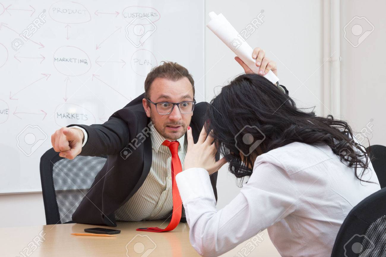 Angry boss firing female colleague by showing the door with his forefinger - 50705355 Angry boss firing female colleague by showing the door with his forefinger - 50705355