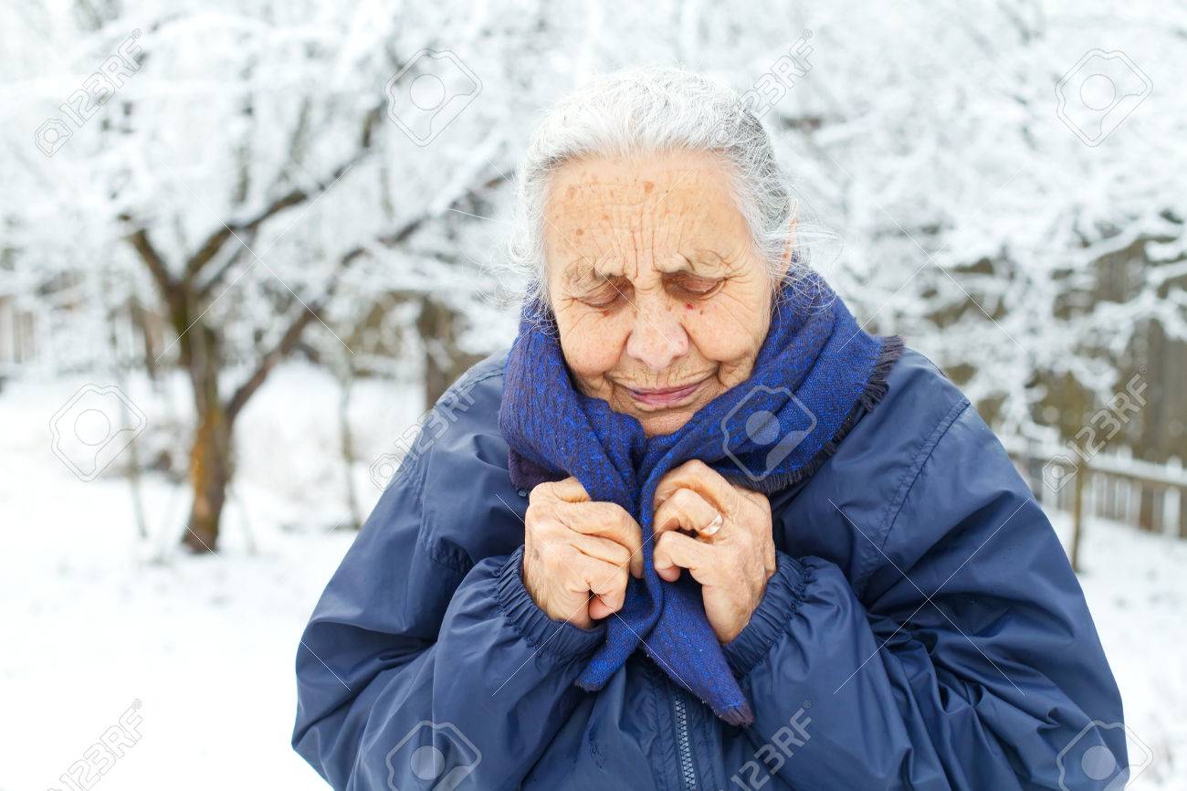 Picture of an old lady feeling cold on wintertime - 68175613 Picture of an old lady feeling cold on wintertime - 68175613