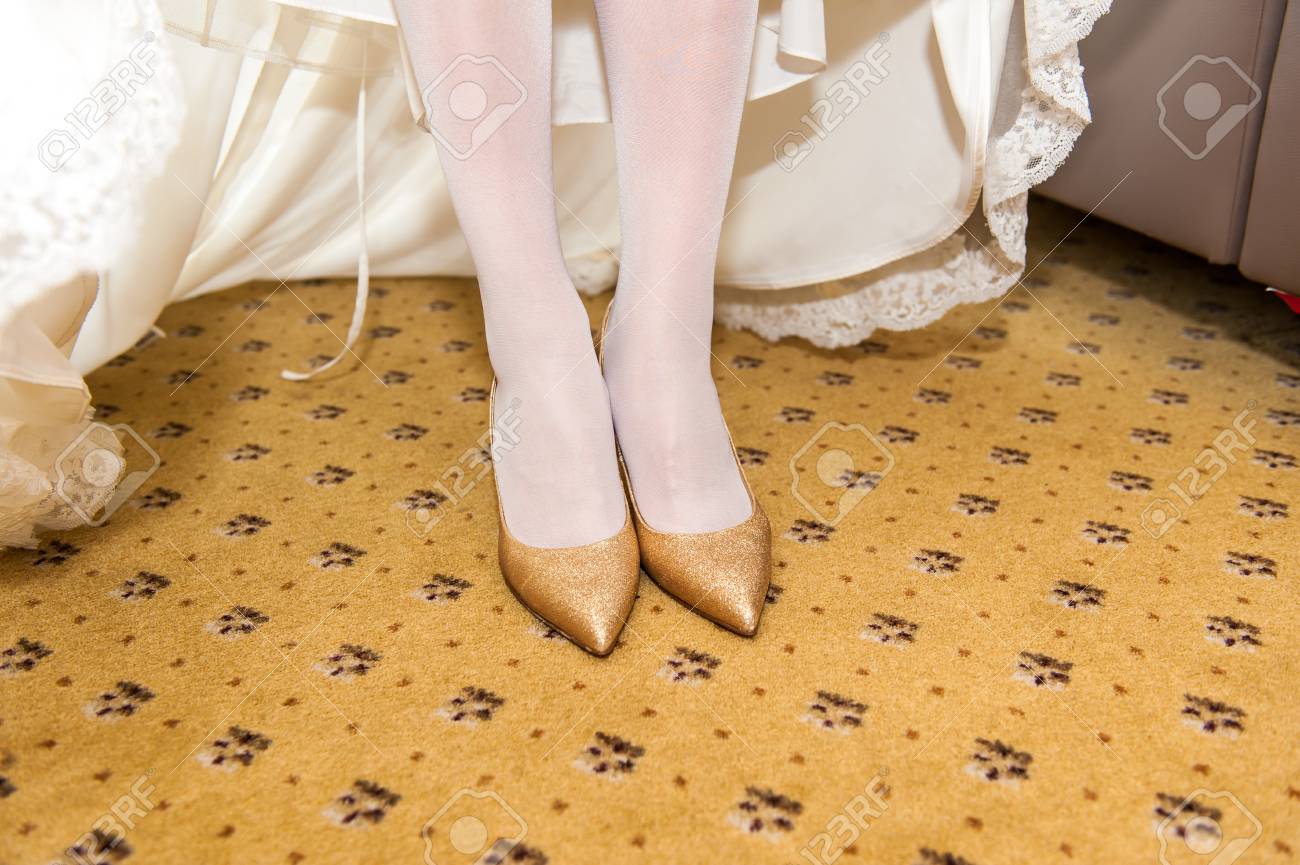 Golden Wedding Shoes On Brides Feet Stock Photo Picture And