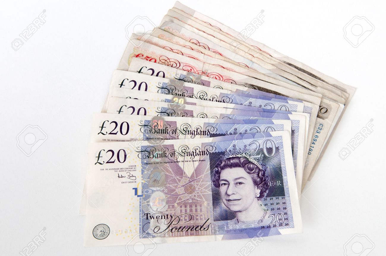a stack of 20 and 50 great british pounds bank notes royalty free