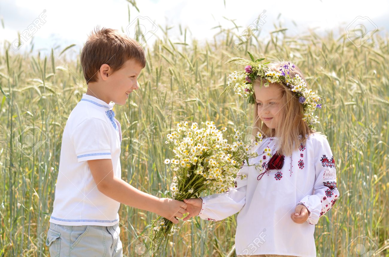 29901033-romantic-boy-giving-flowers-to-