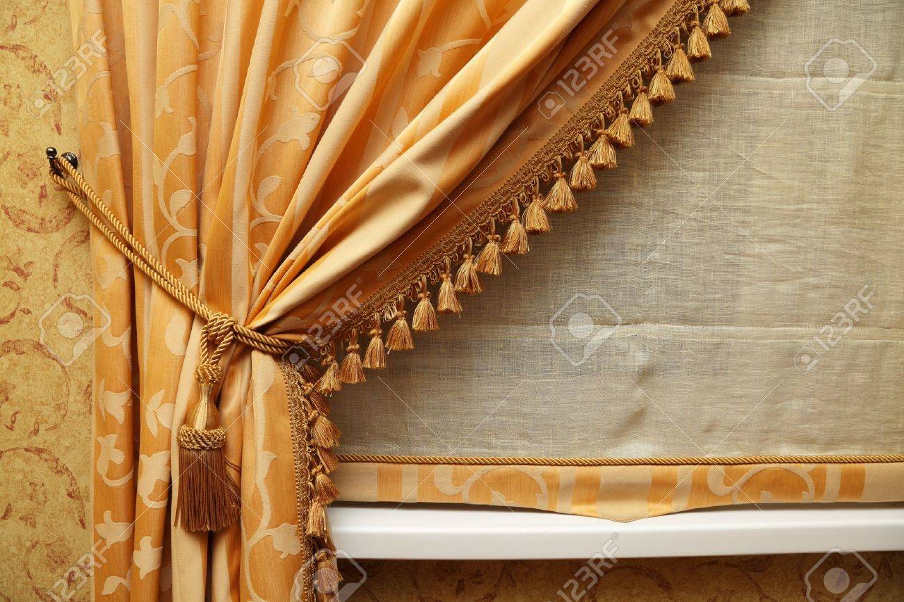 fragment of a beautiful curtain of yellow color stock photo fragment of a beautiful curtain of yellow color stock photo