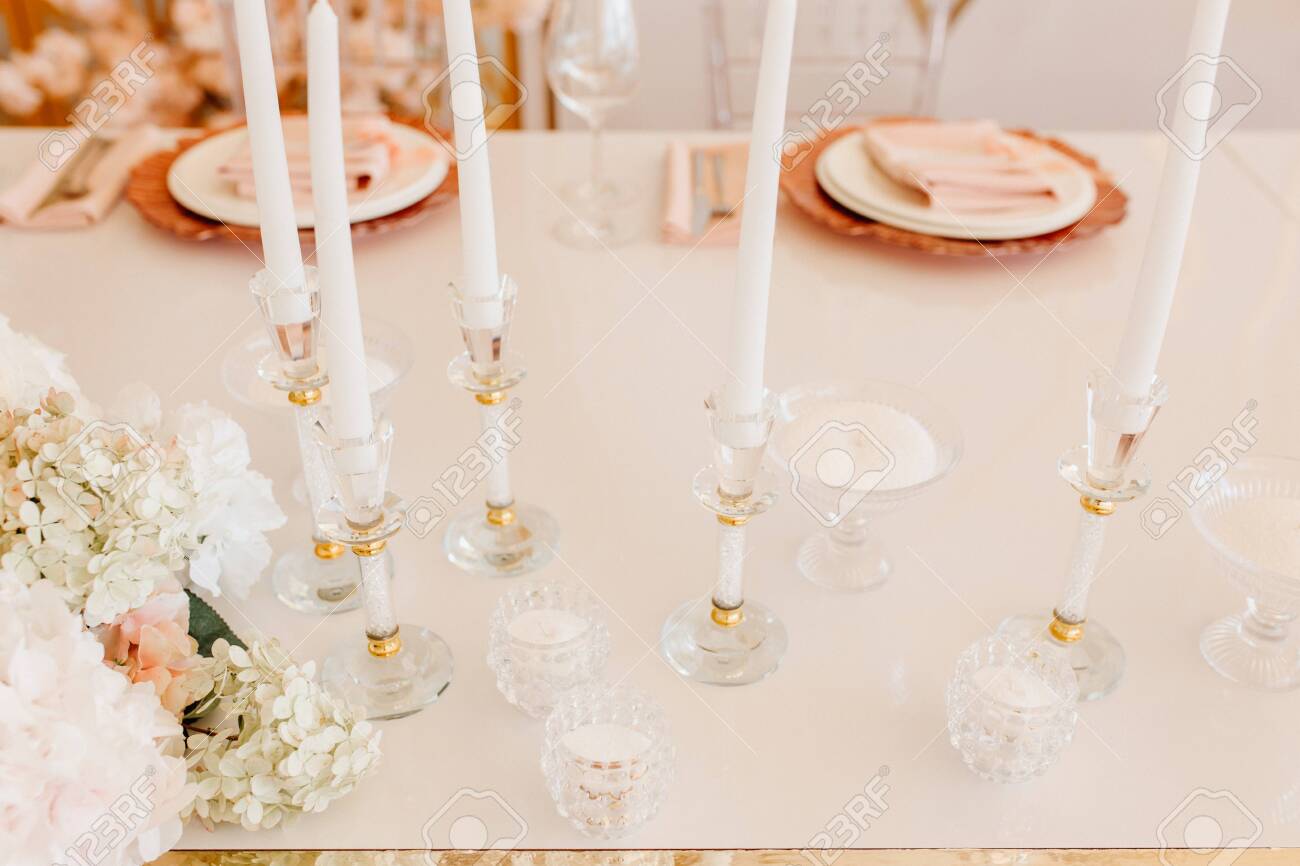 Candles Atanding in Crystal Decorative Candlsticks and Flower Bouquet on Dining Table Horizontal Photography. Napkin on Plates for Delicious Meal and Wine Glasses on Blurred Background - 138172179 Candles Atanding in Crystal Decorative Candlsticks and Flower Bouquet on Dining Table Horizontal Photography. Napkin on Plates for Delicious Meal and Wine Glasses on Blurred Background - 138172179