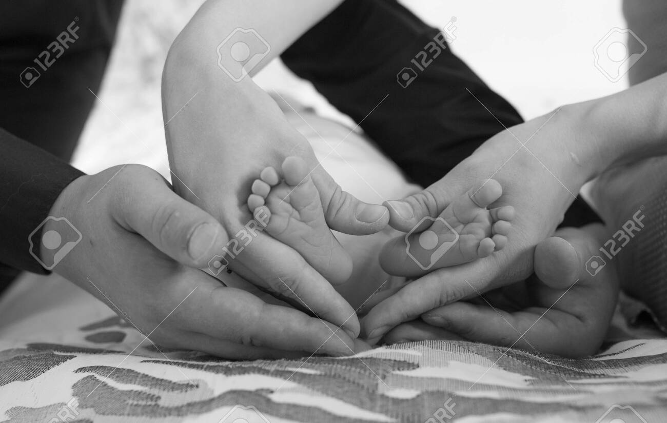Mom And Dad Hug Newborn Baby Legs A Heart Is Formed Which Symbolizes Love Care Affection And Unity Stock Photo Picture And Royalty Free Image Image