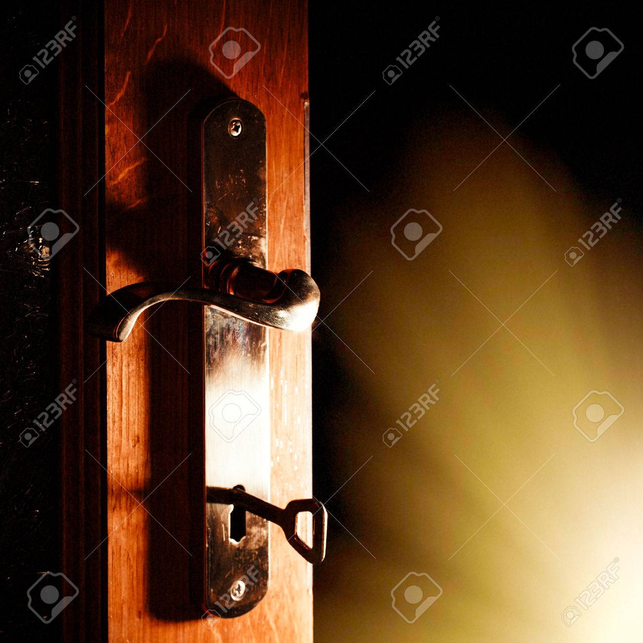 Open Door Dark Room open door with key into the dark room with light stock photo Open Door Dark Room open door with key into the dark room with light stock photo