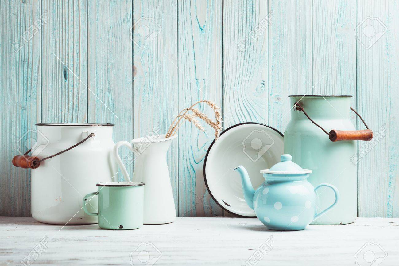 Enamelware on the kitchen table over blue wooden wall - 37860150 Enamelware on the kitchen table over blue wooden wall - 37860150