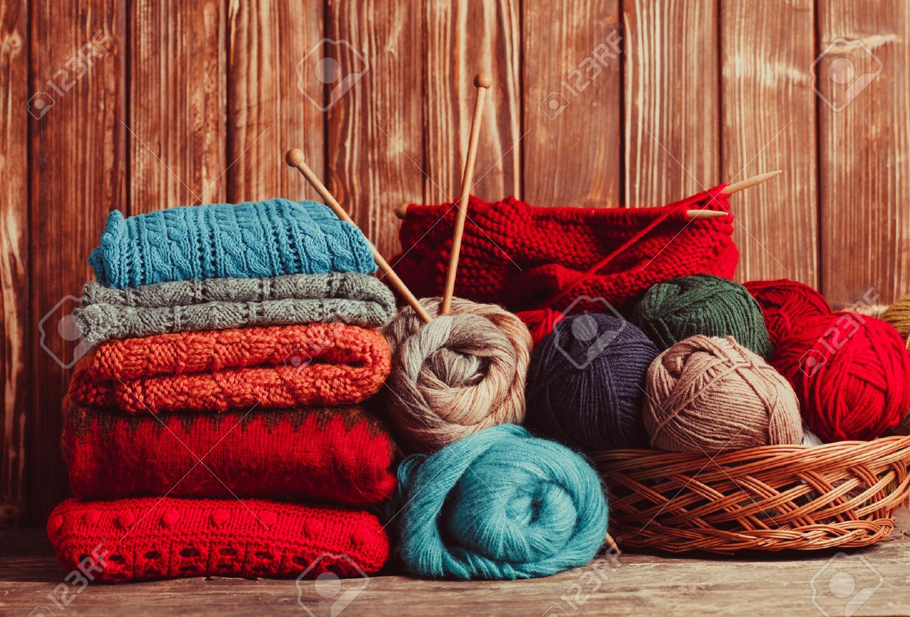 Color threads, knitting needles and clothes on the wooden table - 47374513 Color threads, knitting needles and clothes on the wooden table - 47374513