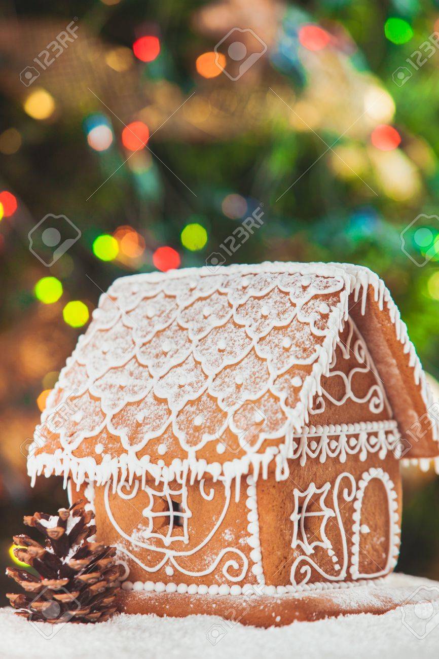 gingerbread house over defocused lights of Chrismtas decorated fir tree - 49835599 gingerbread house over defocused lights of Chrismtas decorated fir tree - 49835599