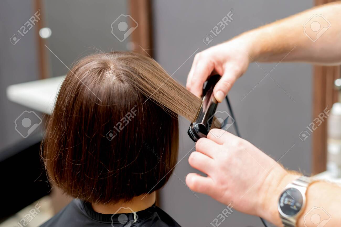 Hairdresser straightening hair Clearance