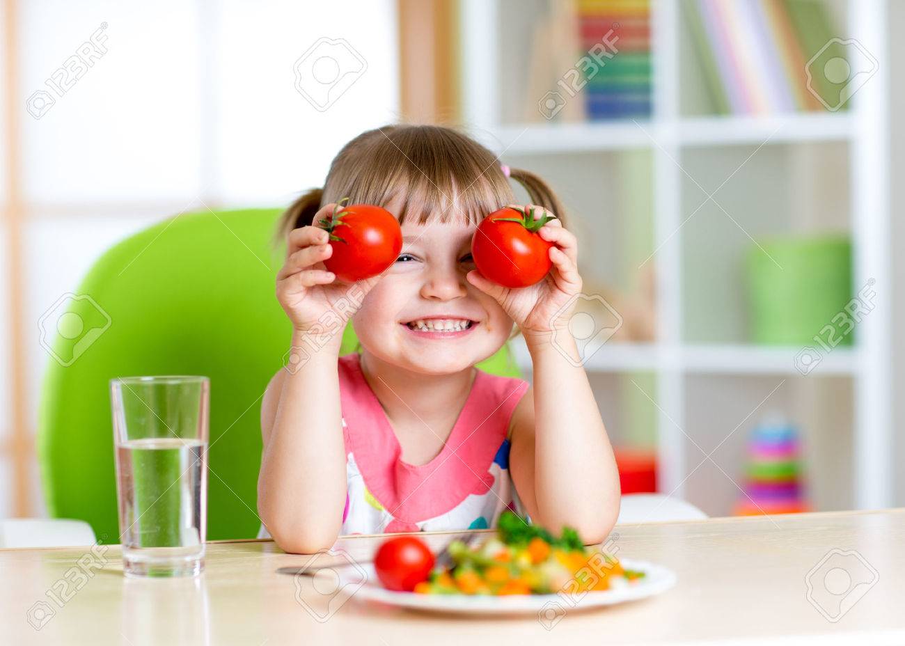 Child with tomatoes. Happy little girl with vegetables at home. - 44393942 Child with tomatoes. Happy little girl with vegetables at home. - 44393942