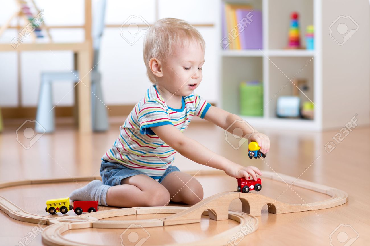 child boy playing with railway toys indoors at home - 53851951 child boy playing with railway toys indoors at home - 53851951