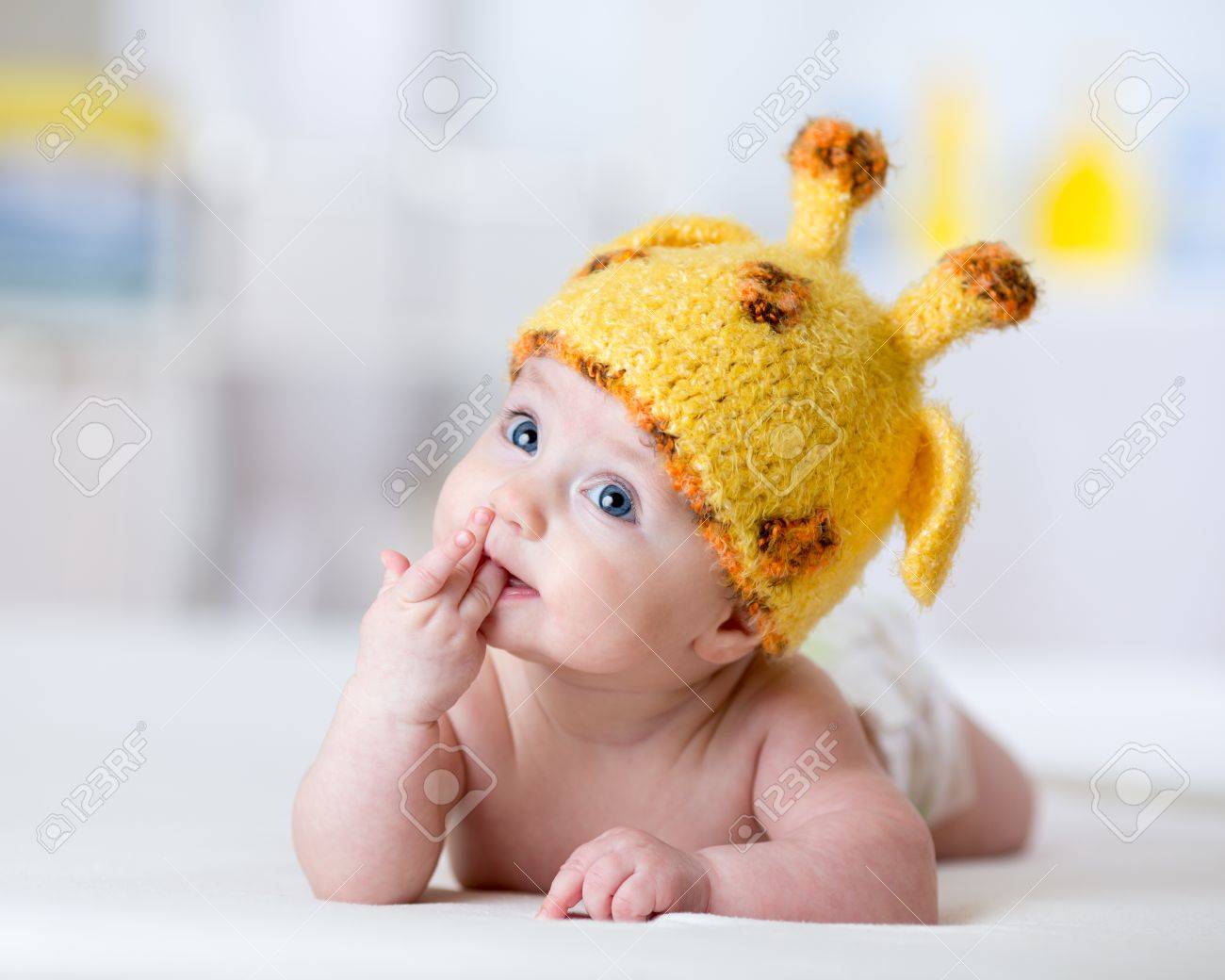 Funny Baby Weared Giraffe Hat Lying On Bed In Nursery Stock P O Funny Baby Weared Giraffe Hat Lying On Bed In Nursery Stock P O
